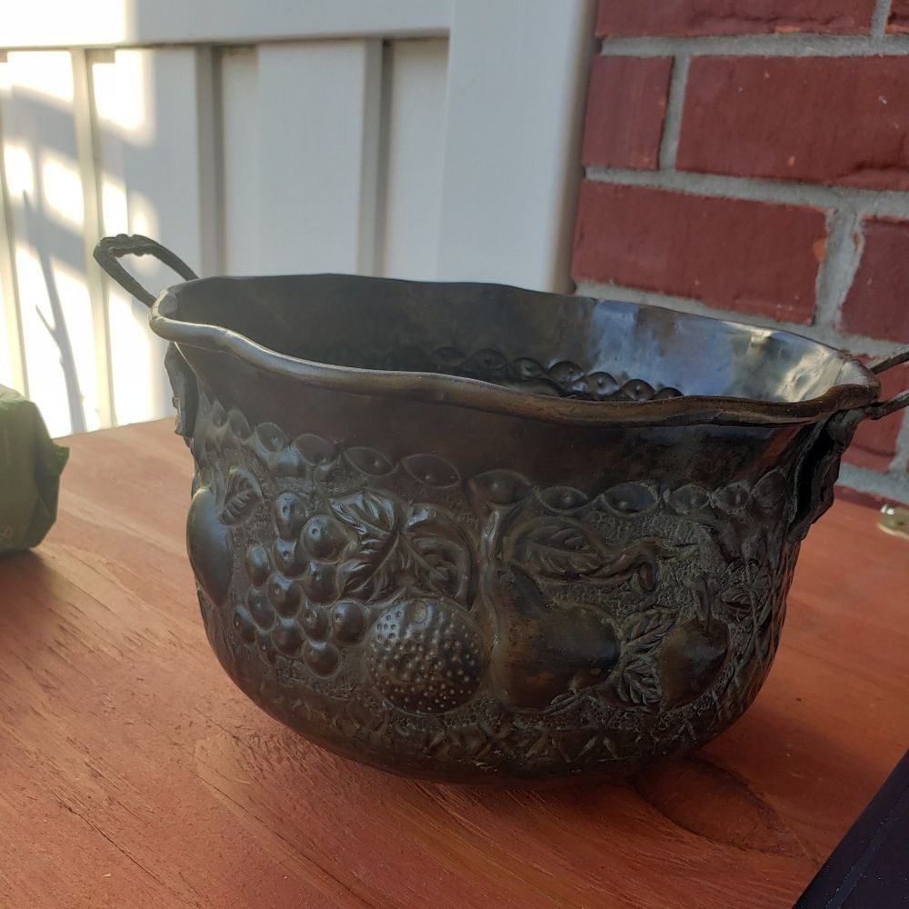Metal bucket with a dimpled design made in India.